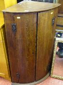 Oak twin door bow front wall hanging corner cupboard