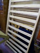 Two modern pine single bed frames and an upholstered headboard