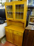 Modern compact light wood dresser of twin leaded and glazed doors over base drawers and cupboards