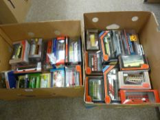 Two boxes of bubble and retail packed diecast model buses and similar