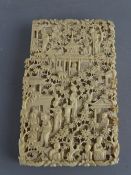 Victorian carved ivory card case, Canton style depicting many figures and pagodas in a garden