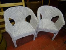 Two white wicker conservatory armchairs