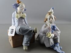 Two Nadal porcelain figurines of seated clowns