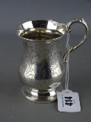 Small silver tankard of waisted form on a pedestal foot with floral chased monogrammed cartouche,