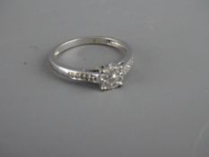 Nine carat white gold ring with diamond set shoulders and cluster setting
