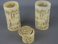 Two early 20th century reticulated ivory sleeve vases and a carved lidded box