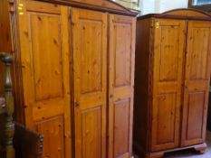 Two reproduction antique pine effect three door and two door wardrobes