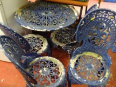 Cast metal and painted circular garden table and four chairs