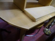 Modern light wood extending dining table and four chairs