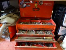 Red three drawer toolbox containing various hammers, files, screwdrivers and sockets