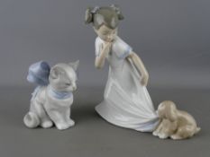 Nao porcelain figurine of a young girl with puppy and one other of a kitten in a large blue bow