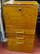 Small office filing cupboard with base drawers and upper filing section with brass bound corners