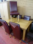 Fine modern oak effect extending dining table and a set of six leather effect dining chairs
