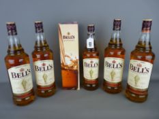 Four 1 litre bottles of Bells Blended Whisky, a boxed 70cl bottle of Bells Whisky and another 70cl