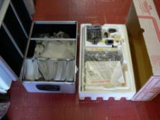 Boxed Redring shower unit and a flight case with miscellaneous contents