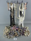 Two mannequin type jewellery stands with a good quantity of costume jewellery necklaces and