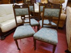 Four neatly carved Edwardian armchairs
