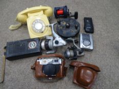 Basket of collectables including vintage dial-up telephone, fishing reels, cased camera etc