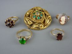 Four nine carat gold dress rings and a pinchbeck style circular brooch
