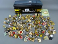 Vintage tin containing a large quantity of collectable buttonhole badges