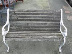 Wooden slatted garden bench with white cast metal ends