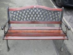 Garden bench with lattice pierced back and metal cast ends and wooden slats