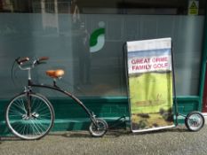 Vintage style penny farthing type bicycle with advertising extension