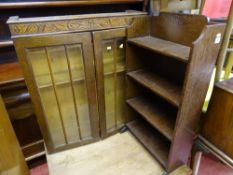 Twin glazed door display cabinet with carvings and a four shelf polished wood slim bookcase