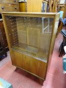 Compact mid Century bookcase cupboard with twin sliding glass doors over base cupboards