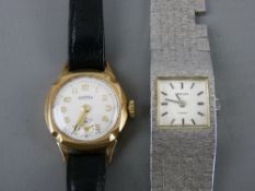 Lady's nine carat gold encased Roma wristwatch with leather strap and a lady's square dial white