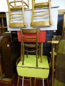 Vintage yellow formica topped drop leaf kitchen table with chairs and a vintage red formica topped