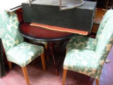Polished wood circular extending dining table and four floral upholstered chairs