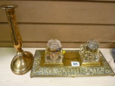 Repousse brass inkstand with lidded glass ink pots and a brass candlestick