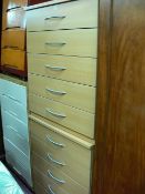 Pair of modern light wood matching five drawer bedroom chests