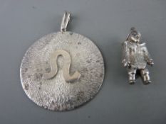 Art silver circular pendant, 19.5 grms and a sterling silver figural pendant charm, 16 grms