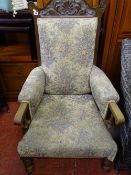 Carved wood oak armchair with floral upholstery