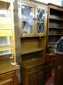 Compact and shaped cabinet with upper glazed and leaded doors and lower base cupboard with central