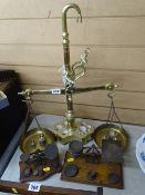 Brass set of vintage shop scales with a quantity of weights and two other smaller retail/chemist's