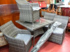Excellent rattan garden/conservatory set comprising glass topped table, four chairs and a parasol