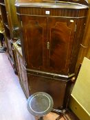 Floorstanding corner cupboard with twin upper doors with slider and base cupboard and a circular