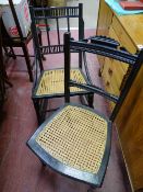 Dark wood cane seated rocking chair and a similar cane seated chair