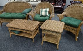 A modern cane work conservatory suite comprising two-seater settee, pair of armchairs and two coffee