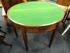 A walnut half-moon foldover card table with front drawer on tapered supports Condition reports