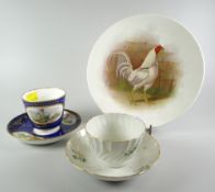 A Minton porcelain deep blue ground porcelain cup and saucer, decorated with panels of poultry and