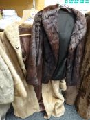 A light coloured long fur coat together with a short dark fur jacket Condition reports provided on