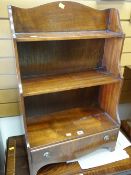 A reproduction mahogany open waterfall bookcase with base drawer Condition reports provided on