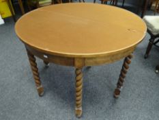A light oak foldover half moon card table with barley-twist legs Condition reports provided on