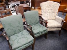 Two vintage Parker Knoll armchairs together with two red upholstered wingback armchairs and a modern