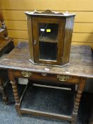 Antique oak single-drawer table on barley-twist supports and a miniature glazed door hanging