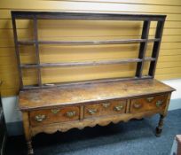 Antique oak Welsh dresser with raised three-drawer base and open rack, 161cms high- Condition